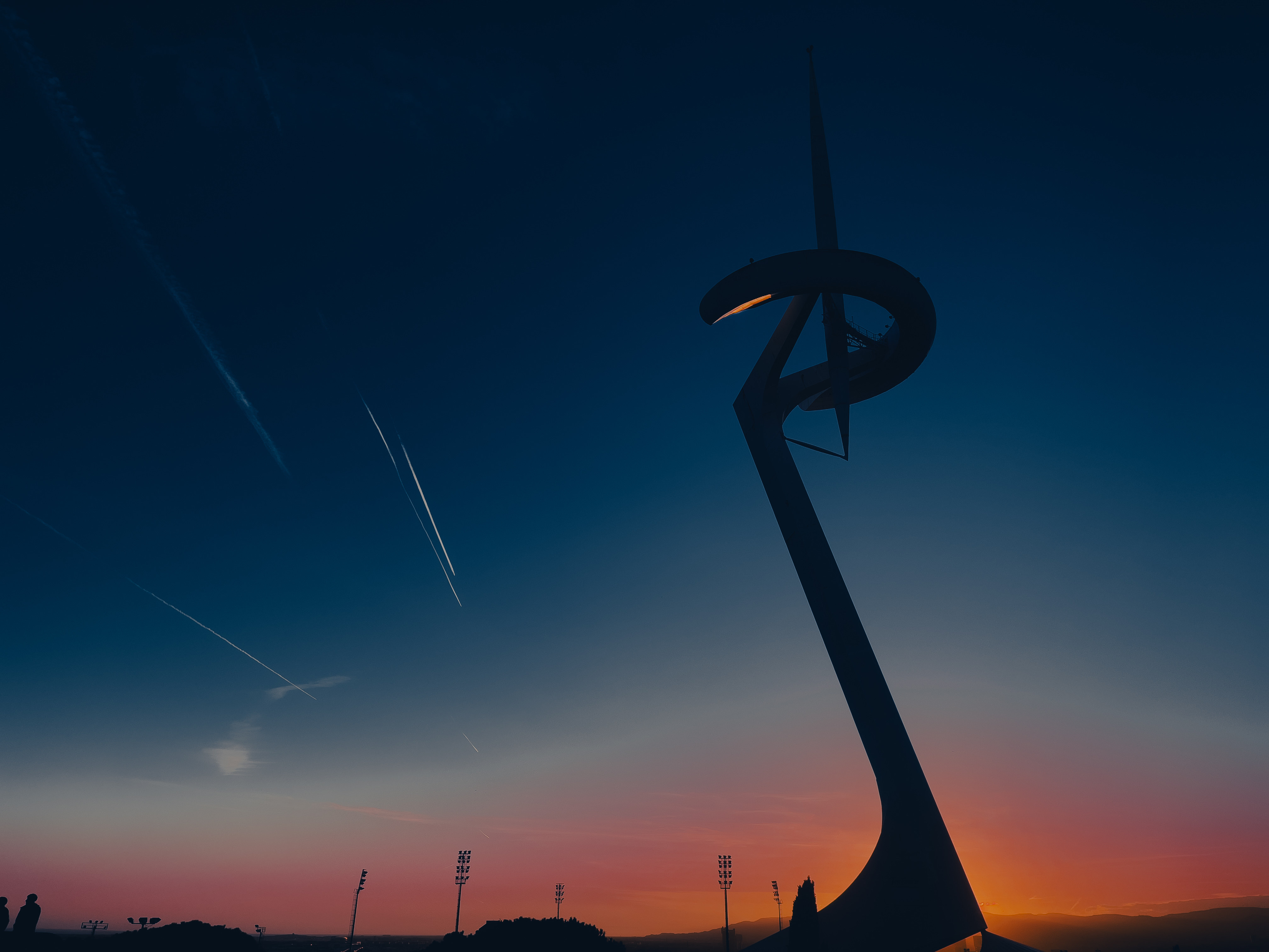 a statue of a wind turbine in the middle of a field